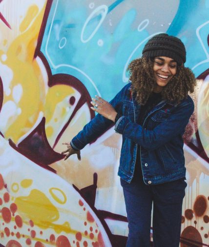 Girl in front of graffiti