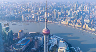Aerial,View,Of,Shanghai,Skyline,And,Winding,River,At,Sunrise